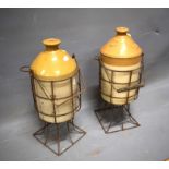 Two Stoneware flagon jars cradled inside a wire crate. Both jar handles missing. Each approx 19 inch