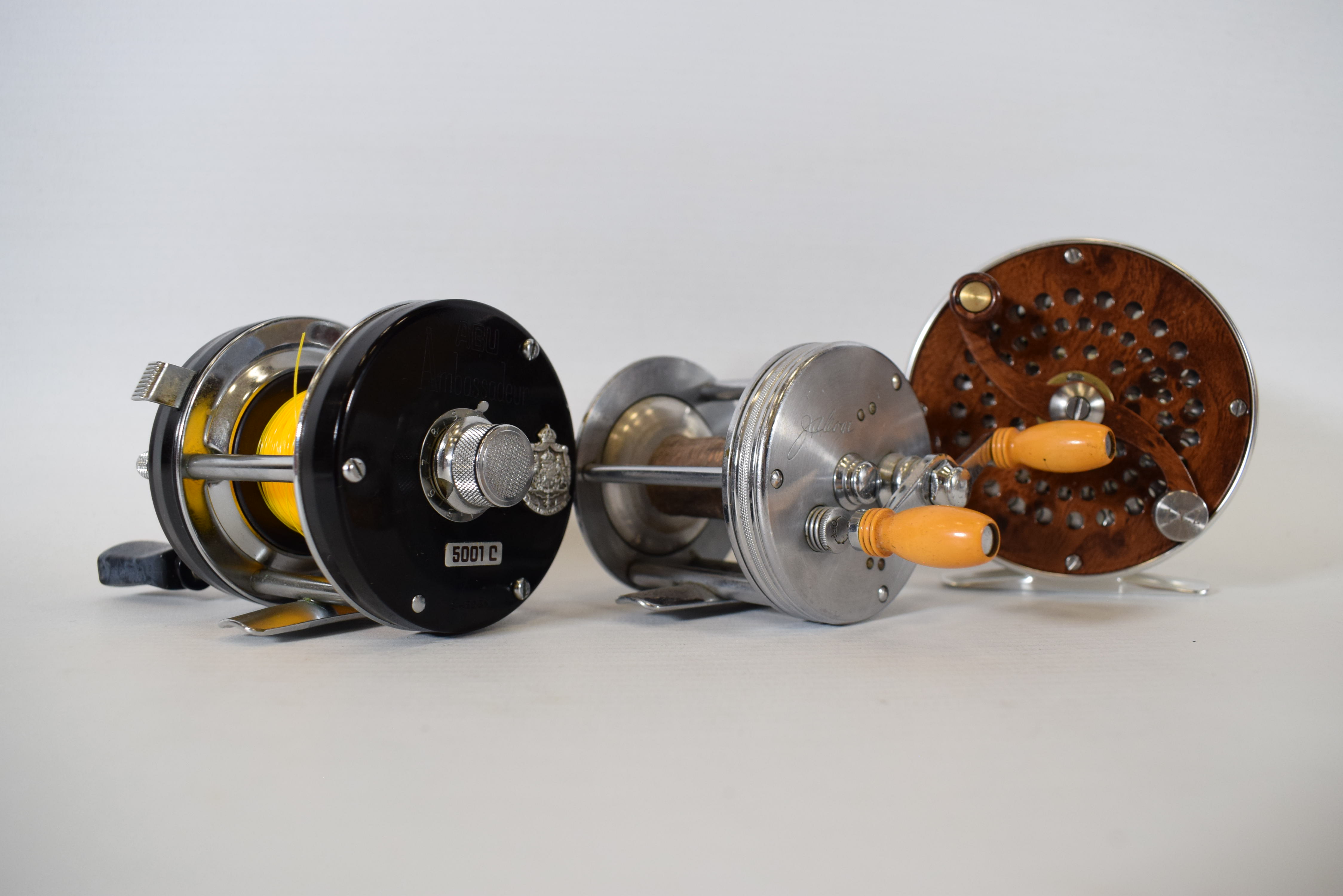 Two Small Spinning or Multiplier reels plus one fly reel.  See photos. 