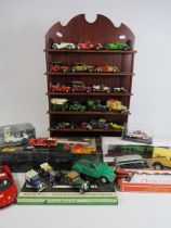 Selection of diecast vehicles some boxed and a wooden display stand.