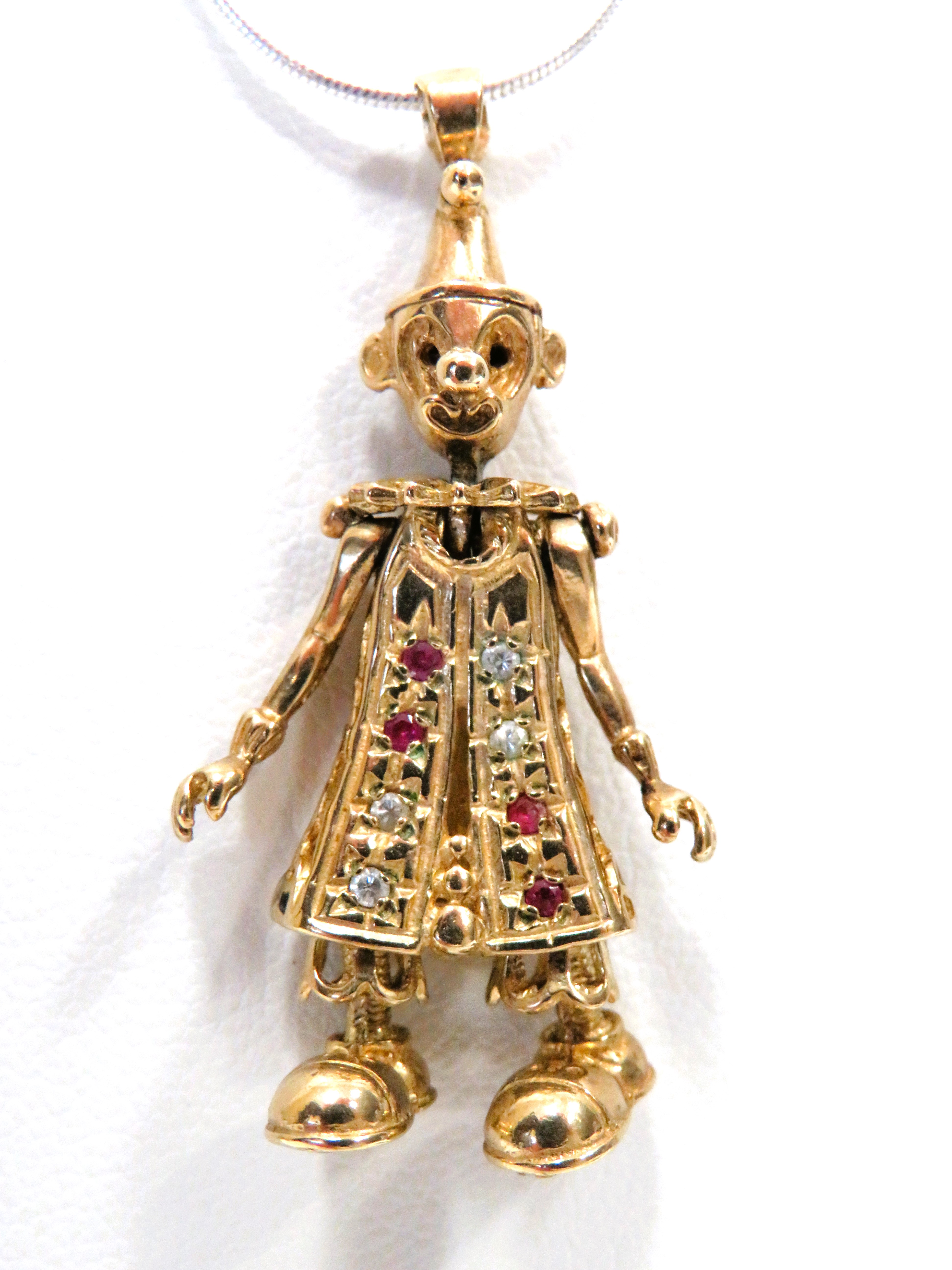 9ct Yellow Gold Pendant as an Articulated clown set with Diamonds & Rubies and measures approx 40mm 