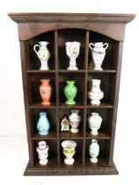 Twelve Collectable miniature Ceramic Vases with Wooden display cabinet. See photos.