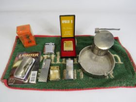 Selection of vintage lighters, a white metal ashtray and a beer mat.