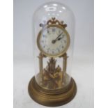 Brass Based Anniversary clock under a Glass Dome which measures approx 11 inches tall. Running order