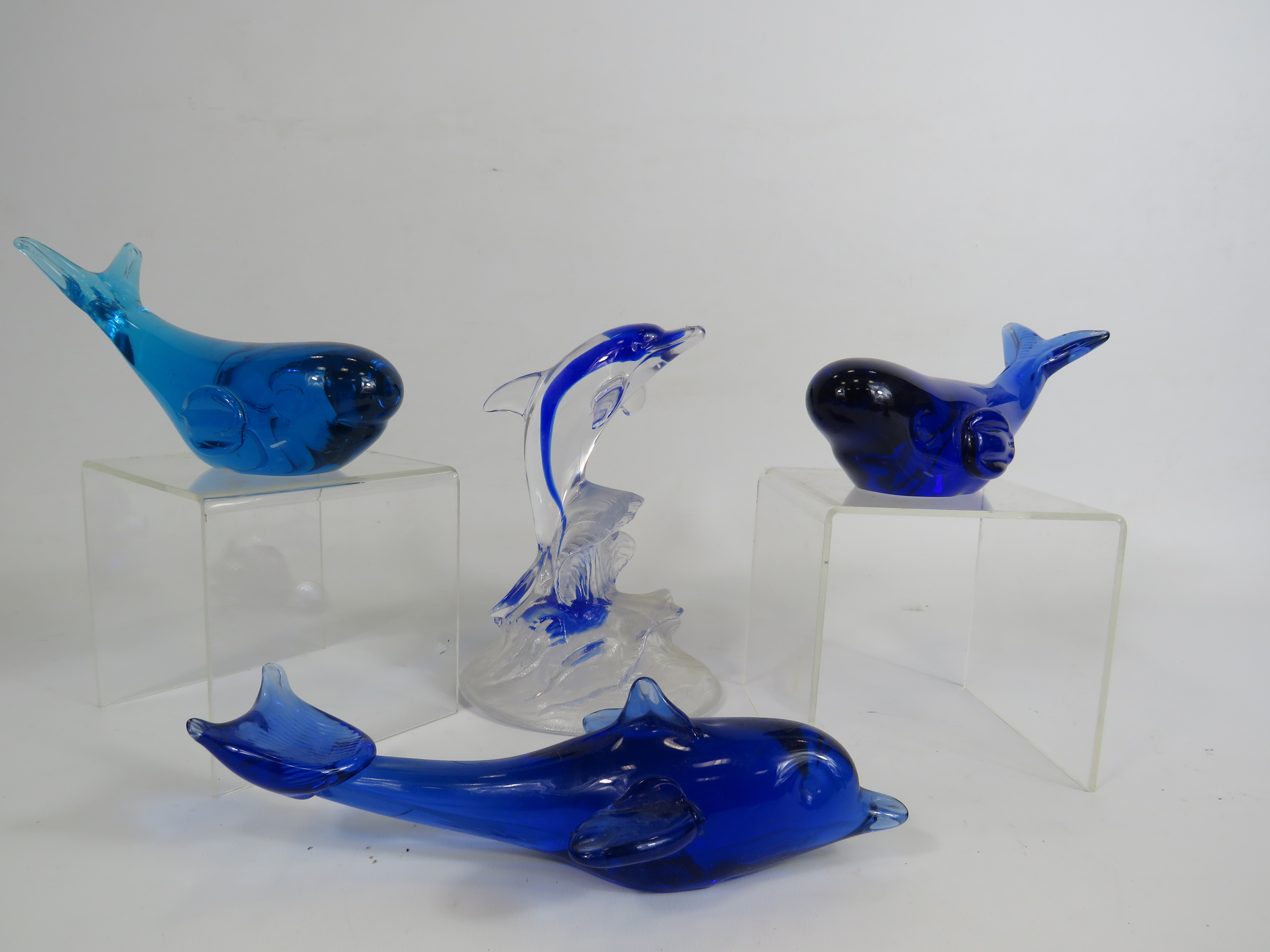 Two whale and two Dolphin art glass paperweights.