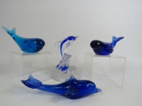 Two whale and two Dolphin art glass paperweights.