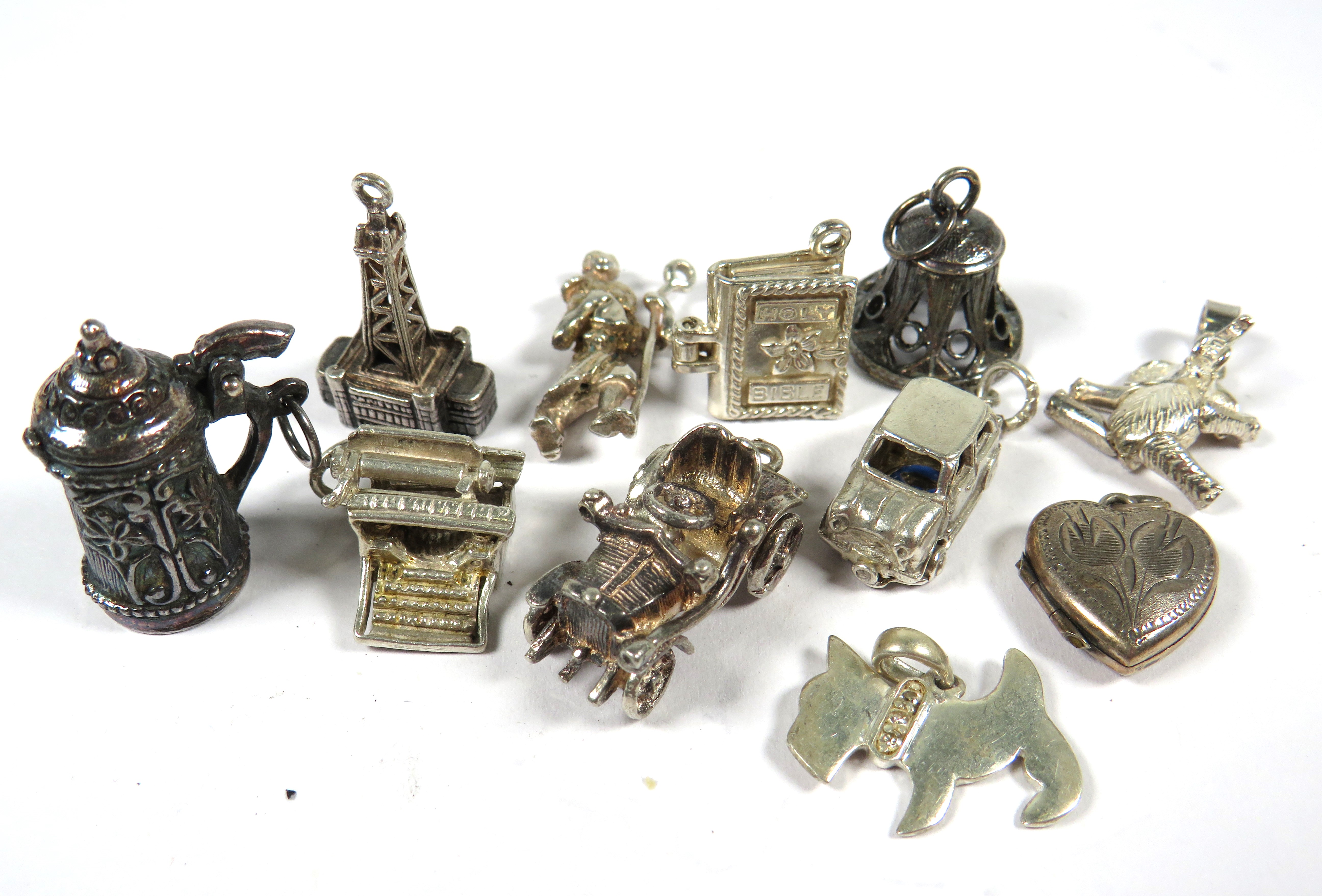 Eleven 925 Sterling Silver Charms.  See photos. 