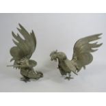 Pair of white metal fighting cockerels, approx 19cm tall.