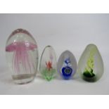 Four art glass paperweights.