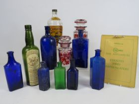 Mixed lot including vintage coloured glass bottles, 2 lidded bohemian glass jars and a tin sign.