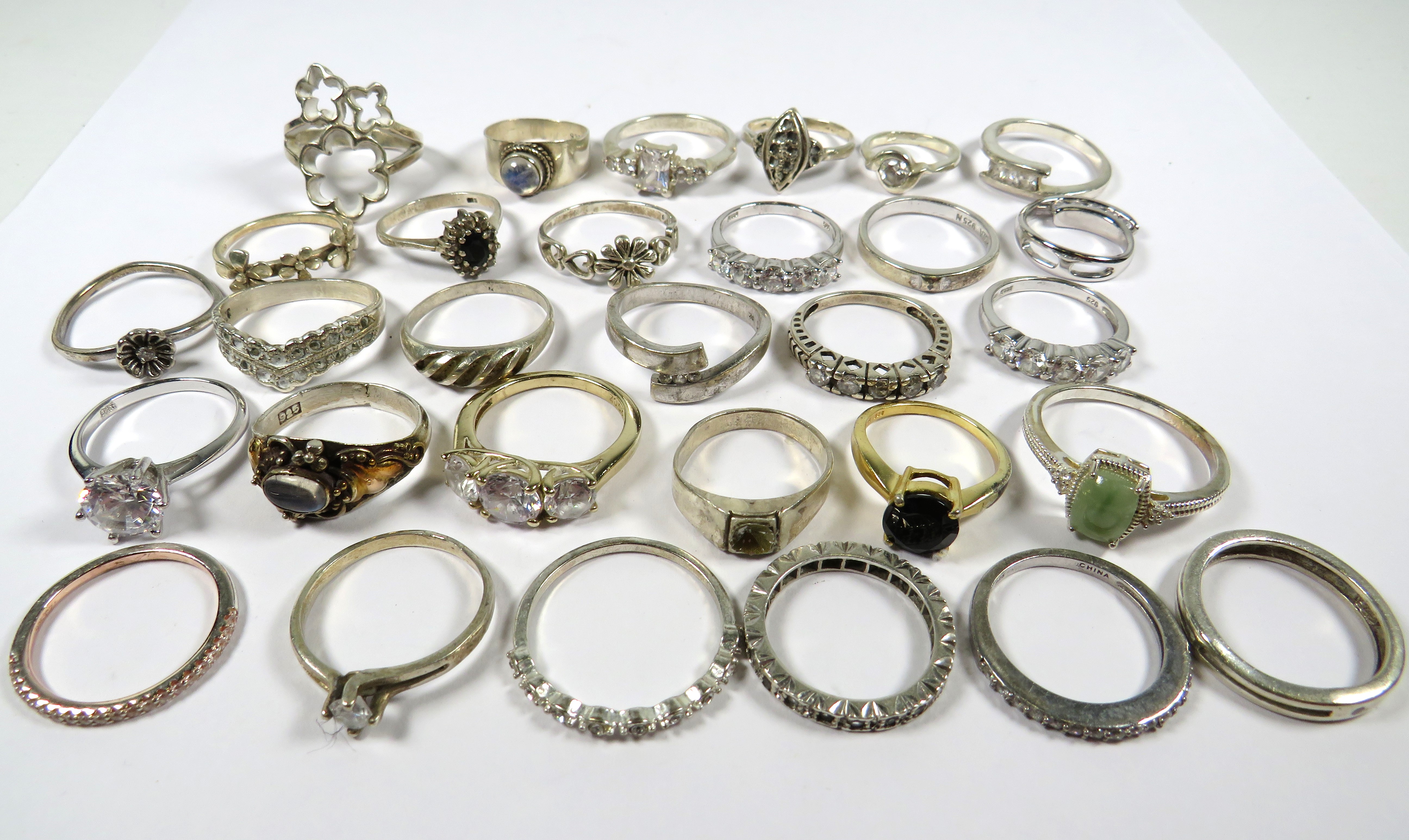 Thirty, 925 Sterling Siver & White metal rings.  See photos. 