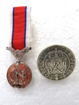 Miniature Hors De Combat, In the line of Duty medal together with a WW2 Kings Badge for Loyal Servic