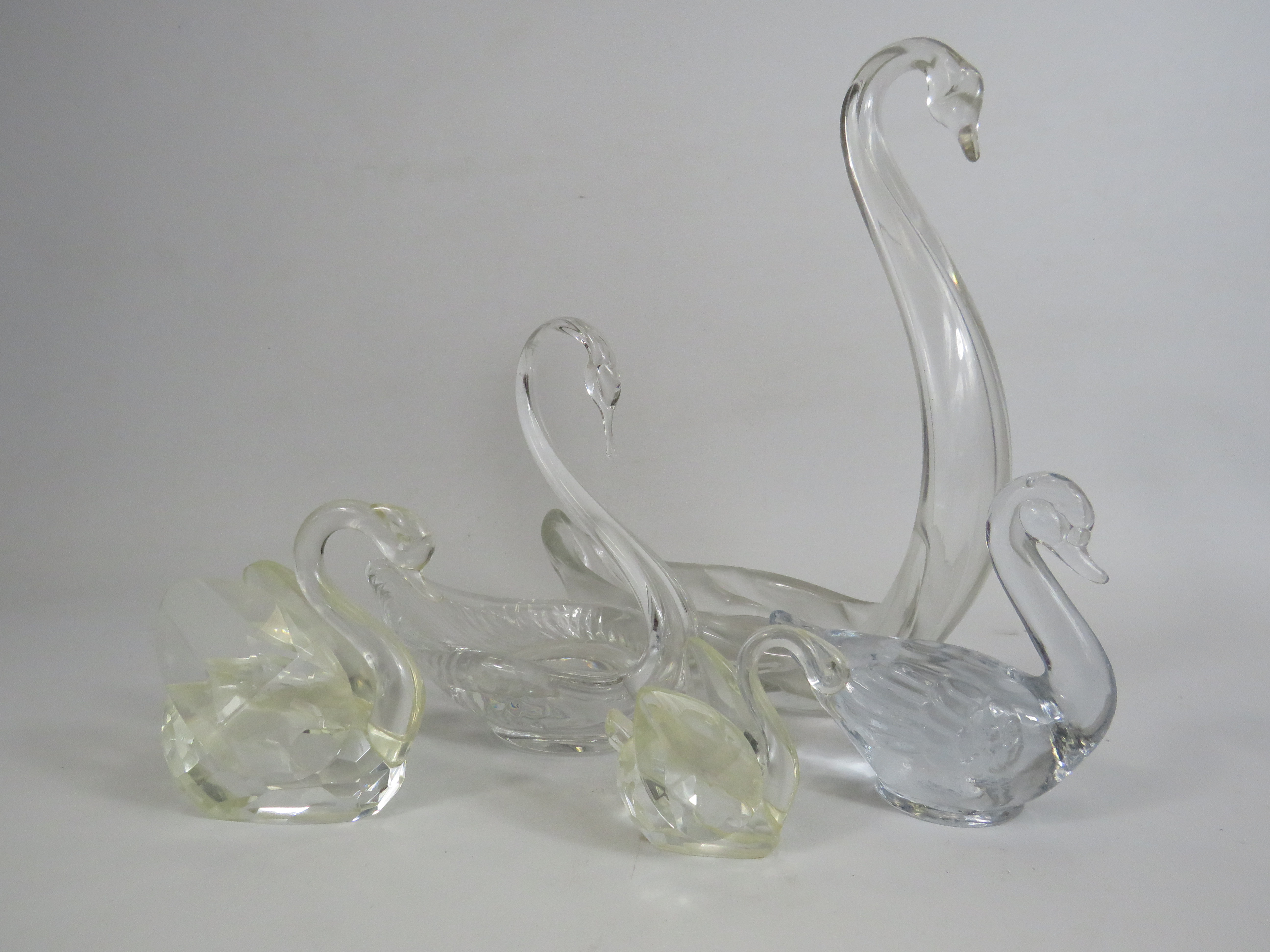 Selection of various crystal glass swan bowls and figurines, the tallest measures 25cm tall.