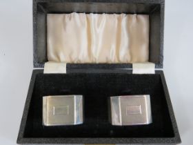 Boxed pair of hallmarked silver napkin rings in original silk and velvet lined box. Total weight app