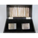 Boxed pair of hallmarked silver napkin rings in original silk and velvet lined box. Total weight app