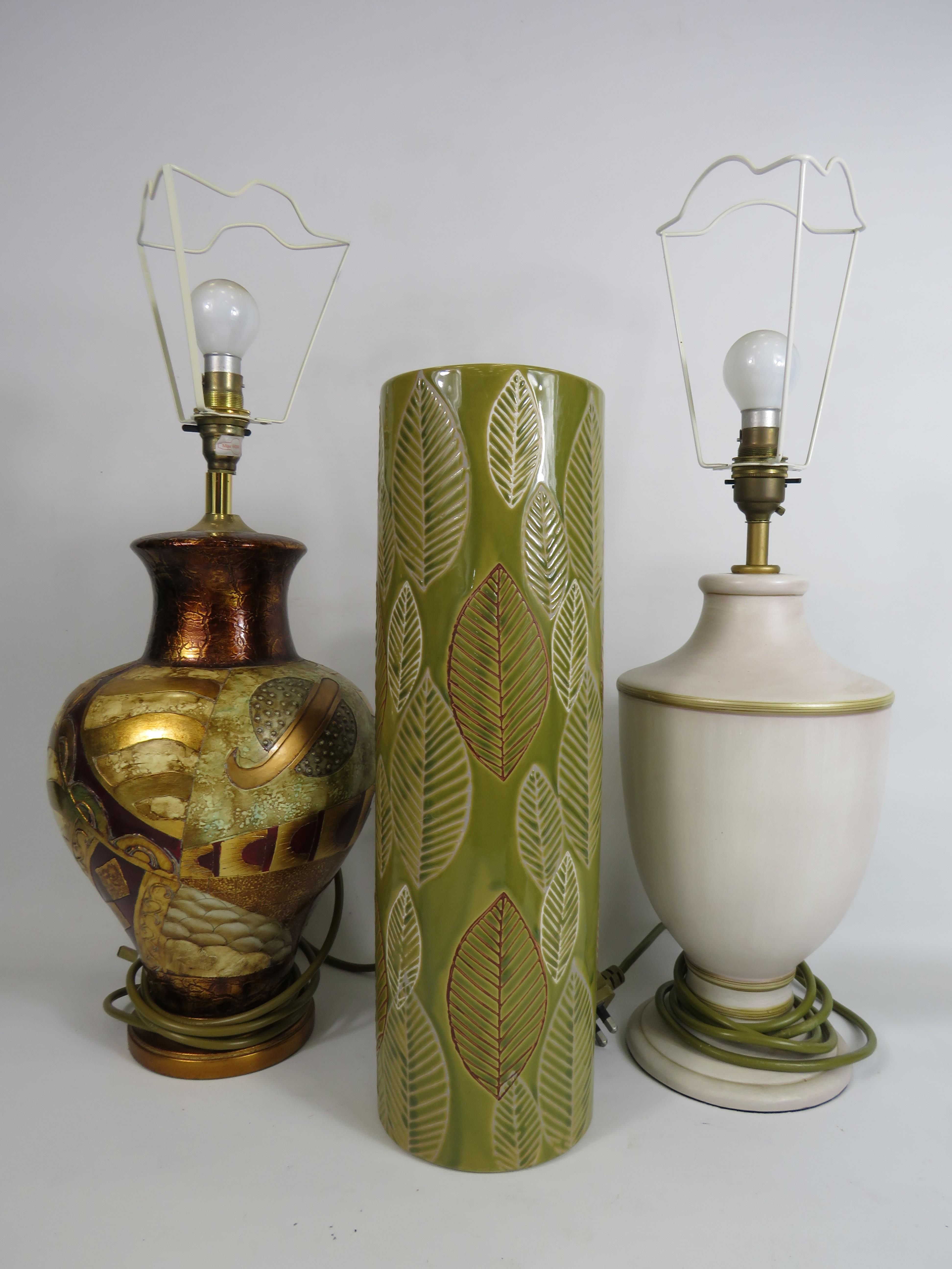 Two modern table lamps with shades and a floor vase.