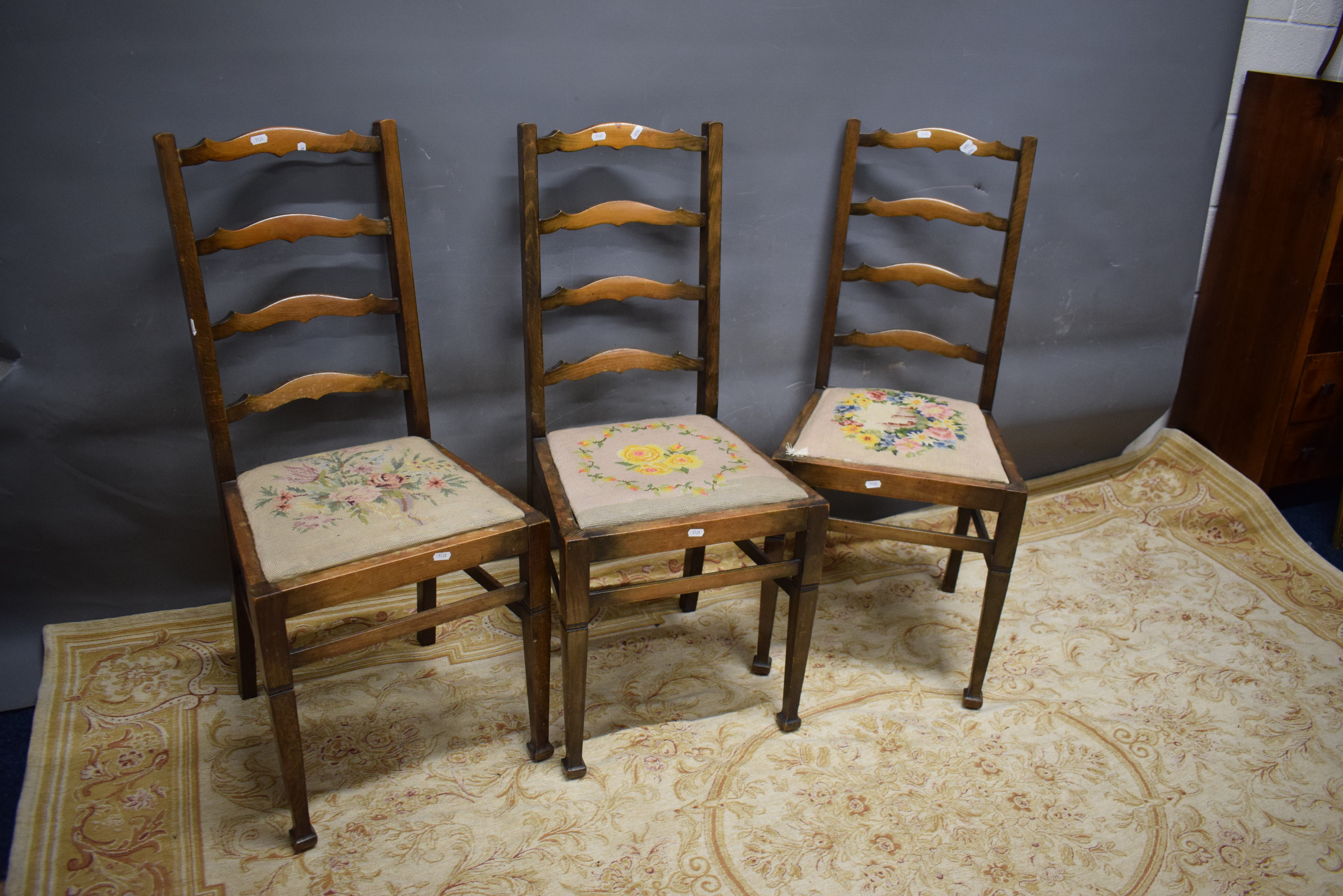Three Ladderback chairs with needlpoint decoration.  See photos. S2