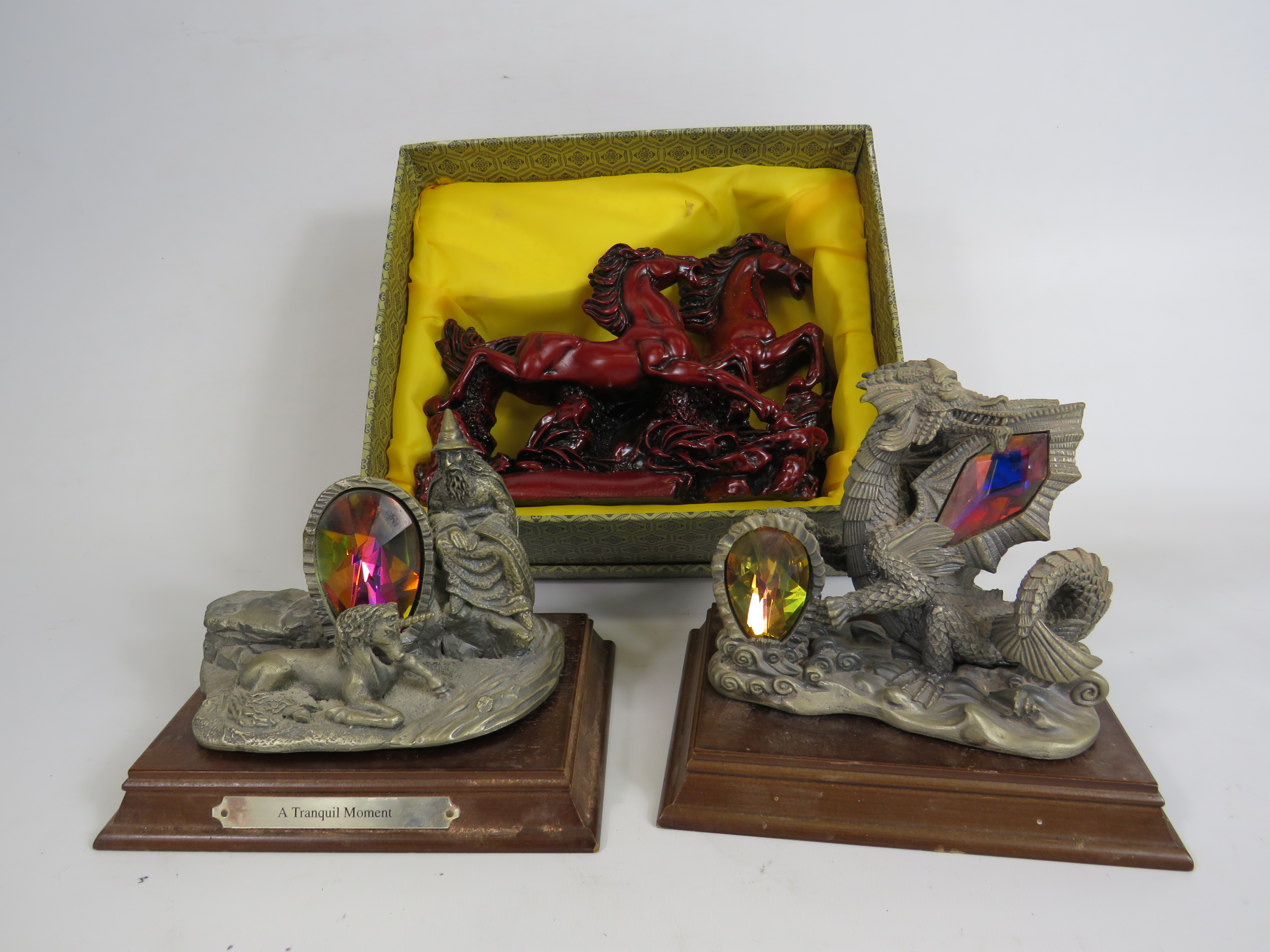 Two Marc locker pewter mythical figurines and a cherry resin galloping horses figurine.