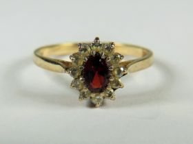 9ct Yellow Gold ring set with a Central Garnet with CZ Surround.   Finger size 'Q'  2.0g