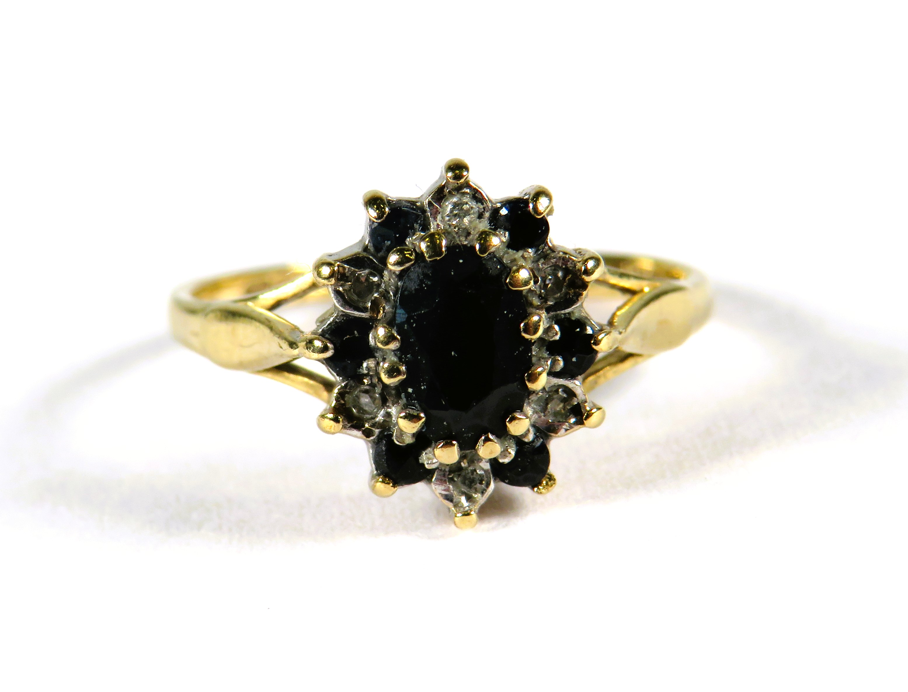 9ct Yellow Gold ring set with a central Sapphire with sapphire and Diamond surround in a flower patt