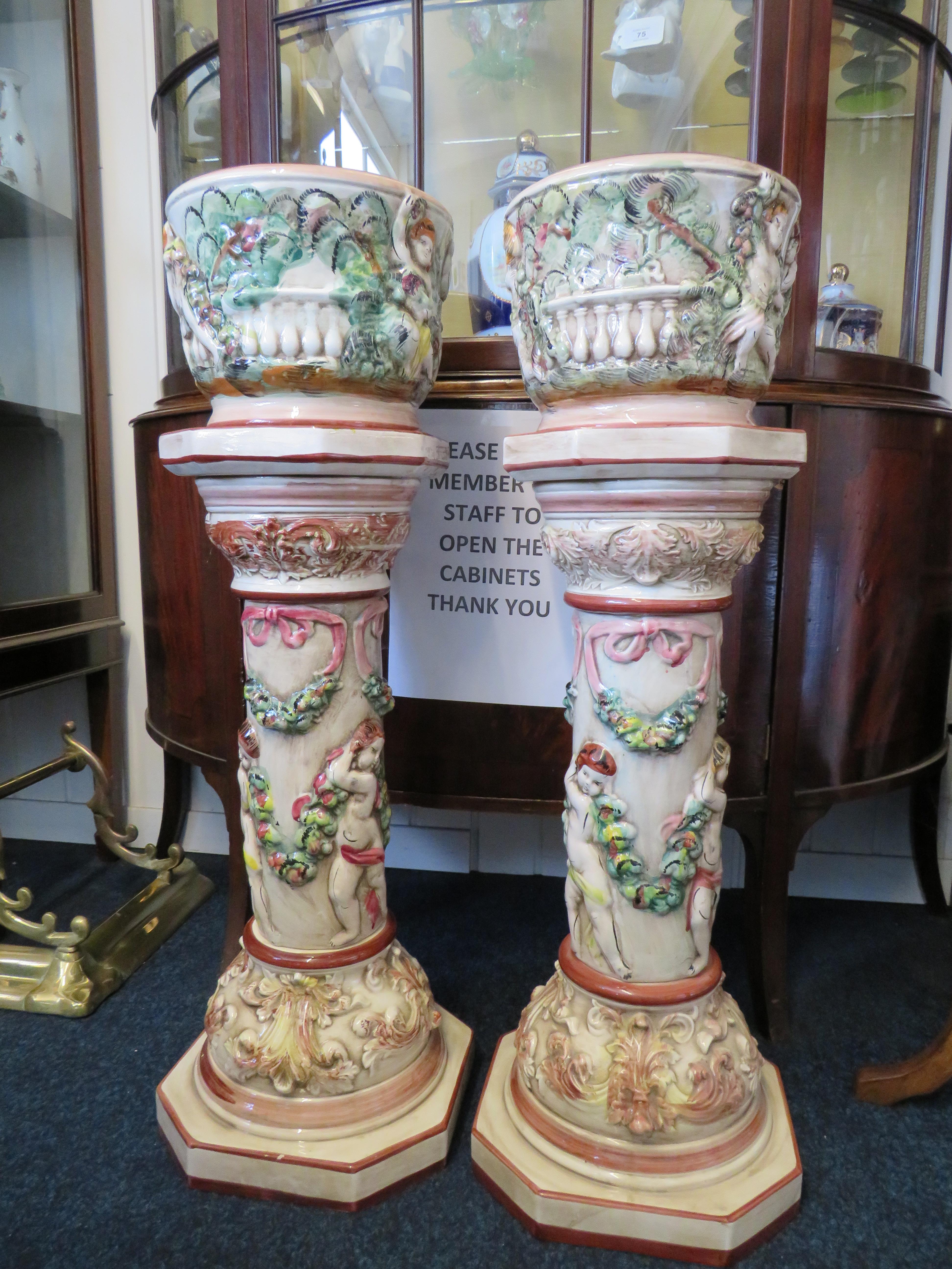 Two Capodimonte Jardineres decorated with cherubs, 32.5" to top of plant pot.