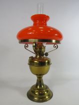 Duplex brass oil lamp with vibrate orange glass shade.