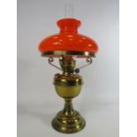 Duplex brass oil lamp with vibrate orange glass shade.