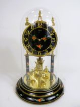Kunzle German made anniversary clock with black faced dial painted with flowers and matching support