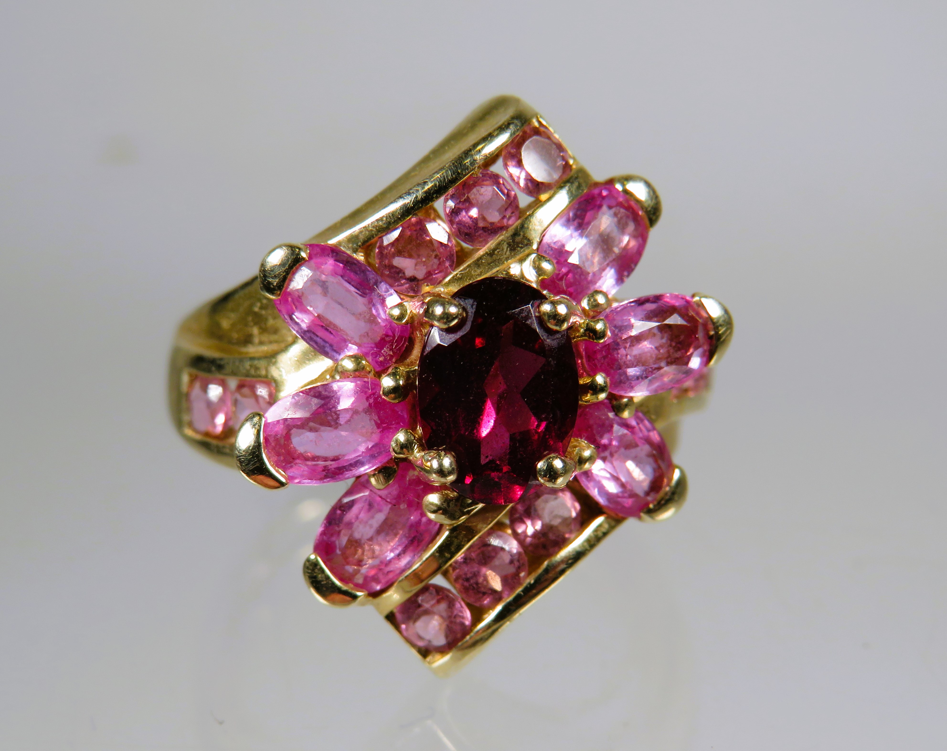 9ct Yellow Gold Ring set with Pink Tourmaline in a flower pattern.   Finger size 'M'    4.5g