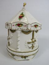 Rare Royal Albert old country roses musical carousel, 22cm. Has had a glued repair to flag.