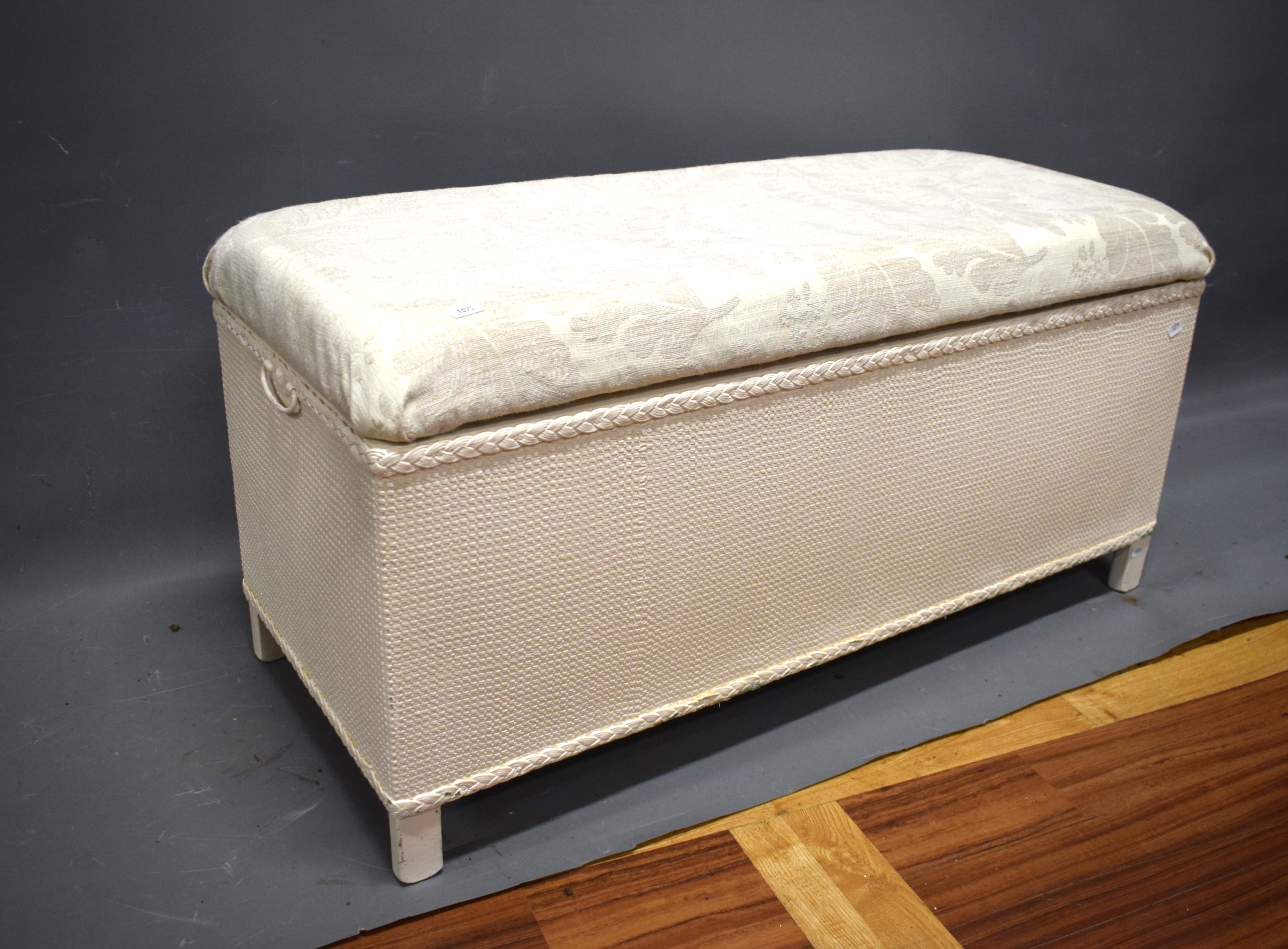 Lloyd loom style blanket box with linen top.   Measures H:18 x W:35 x D:15 Inches. See photos.   S2