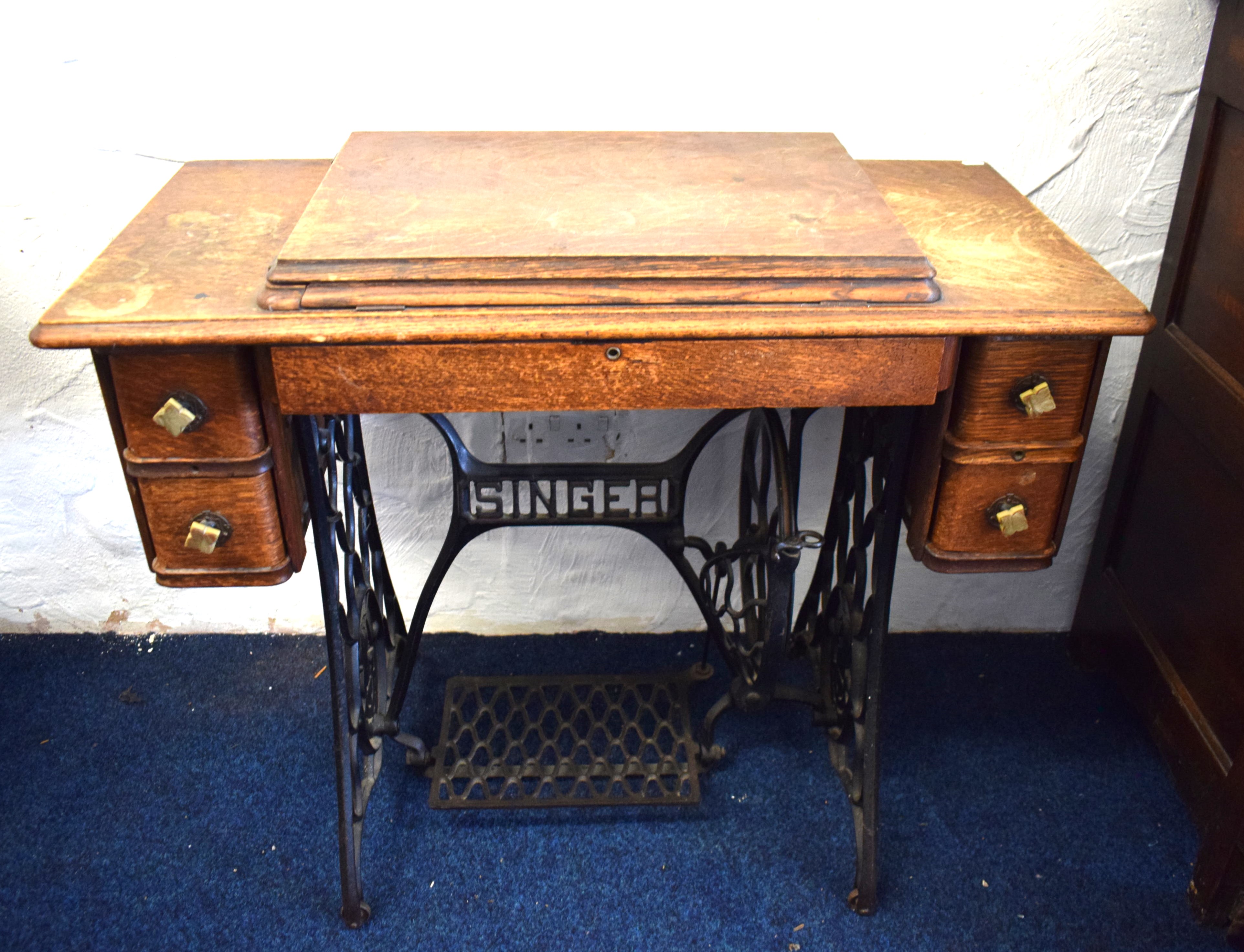 Singer sewing machine treadle table with four drawer cabinet.  See photos. 