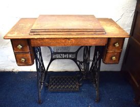 Singer sewing machine treadle table with four drawer cabinet. See photos.