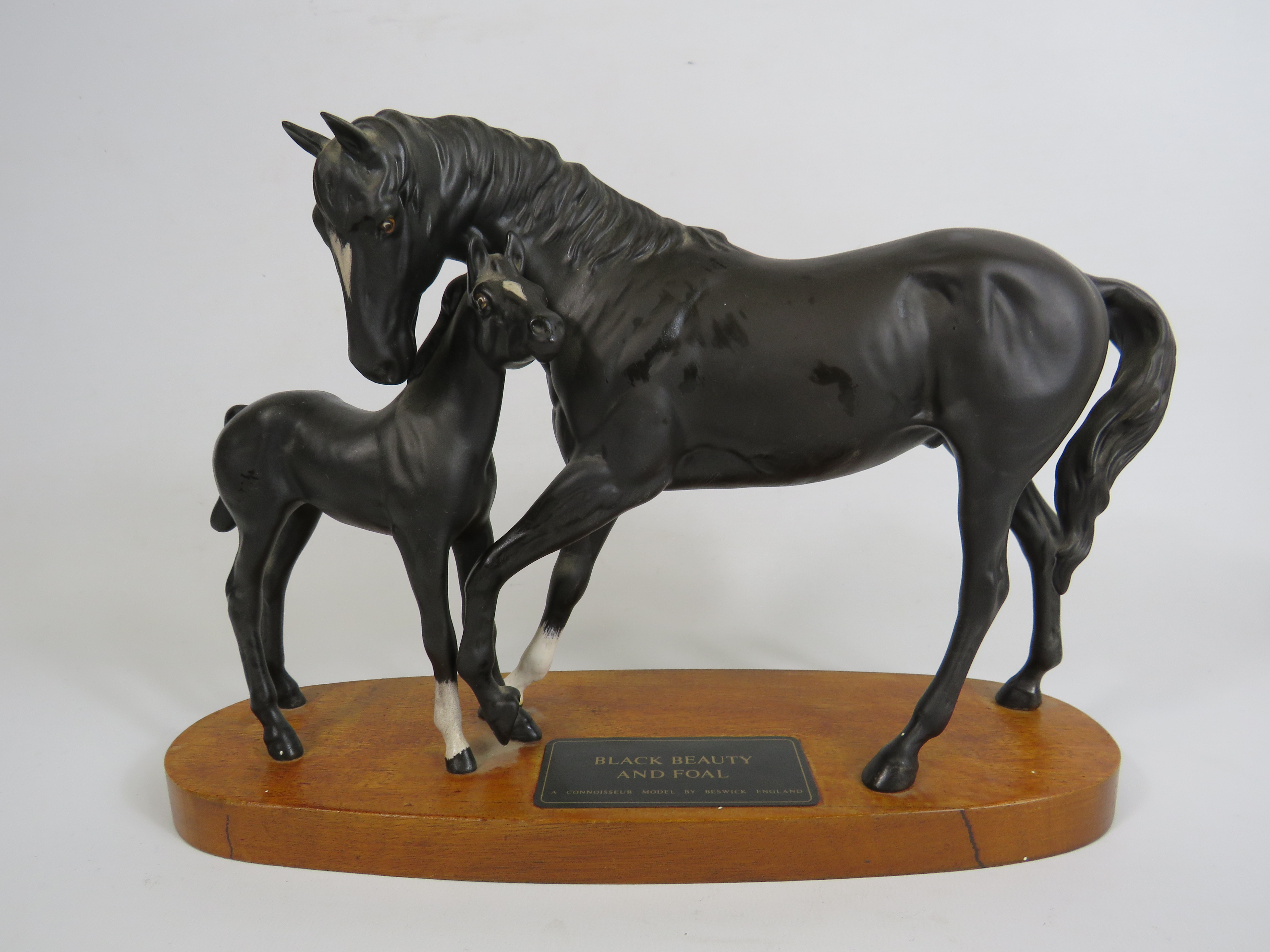 Beswick Connoisseur model of Black beauty and foal standing on a wooden plinth.