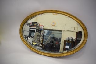 Oval Gilt framed bevelled edged mirror  14 x 23 inches. See photos. 
