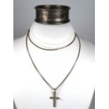 Silver Crucifix hung on a Silver Cage link chain together with a Hallmarked Silver Napkin Ring.   To