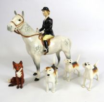 Beswick Huntswomen on grey horse , 3 hounds and a fox.