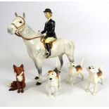 Beswick Huntswomen on grey horse , 3 hounds and a fox.