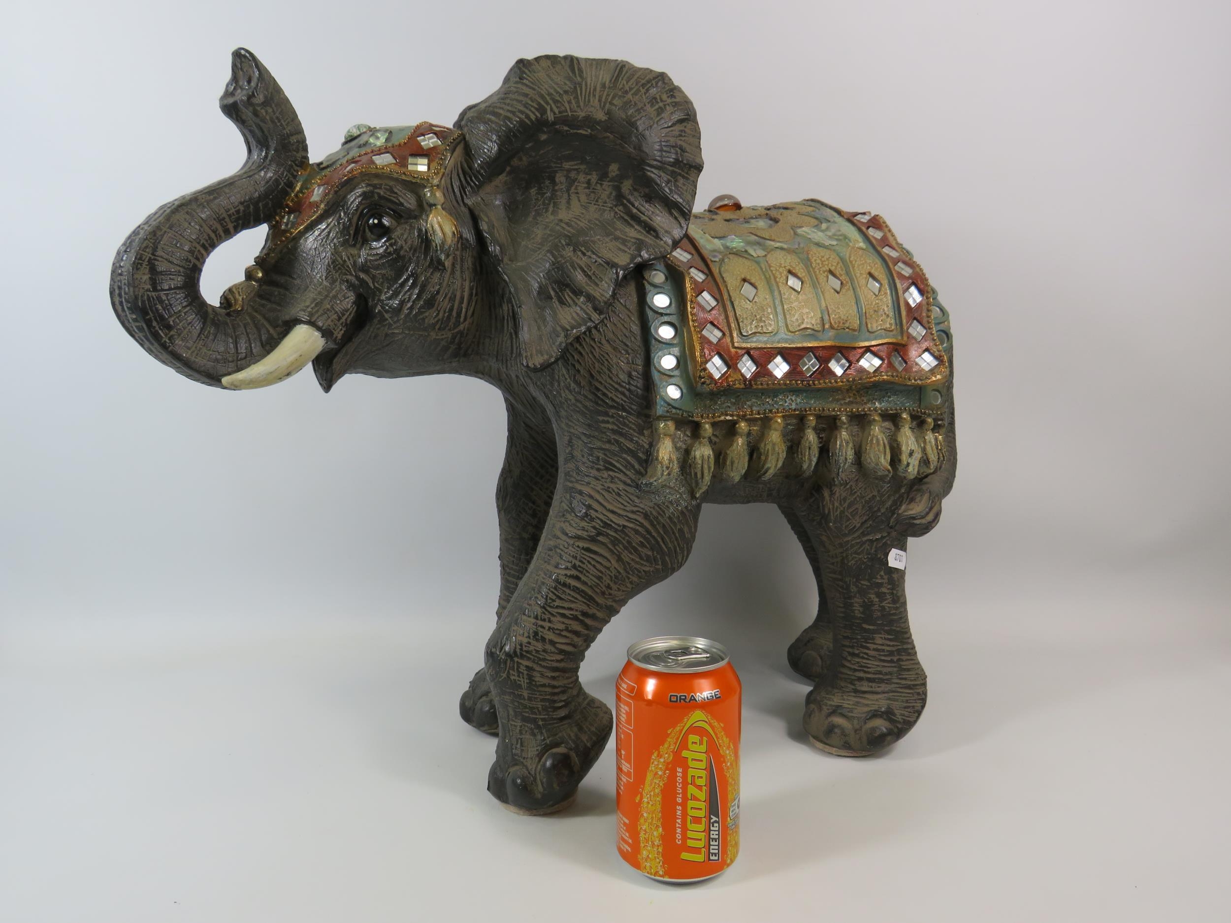 Large resin elephant sculpture decorated with mirrors, jewels and mother of pearl, it stands