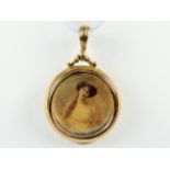 Victorian 9ct Gold Watch fob or pendant set with a glass front and photos.   Measures approx 25mm.  