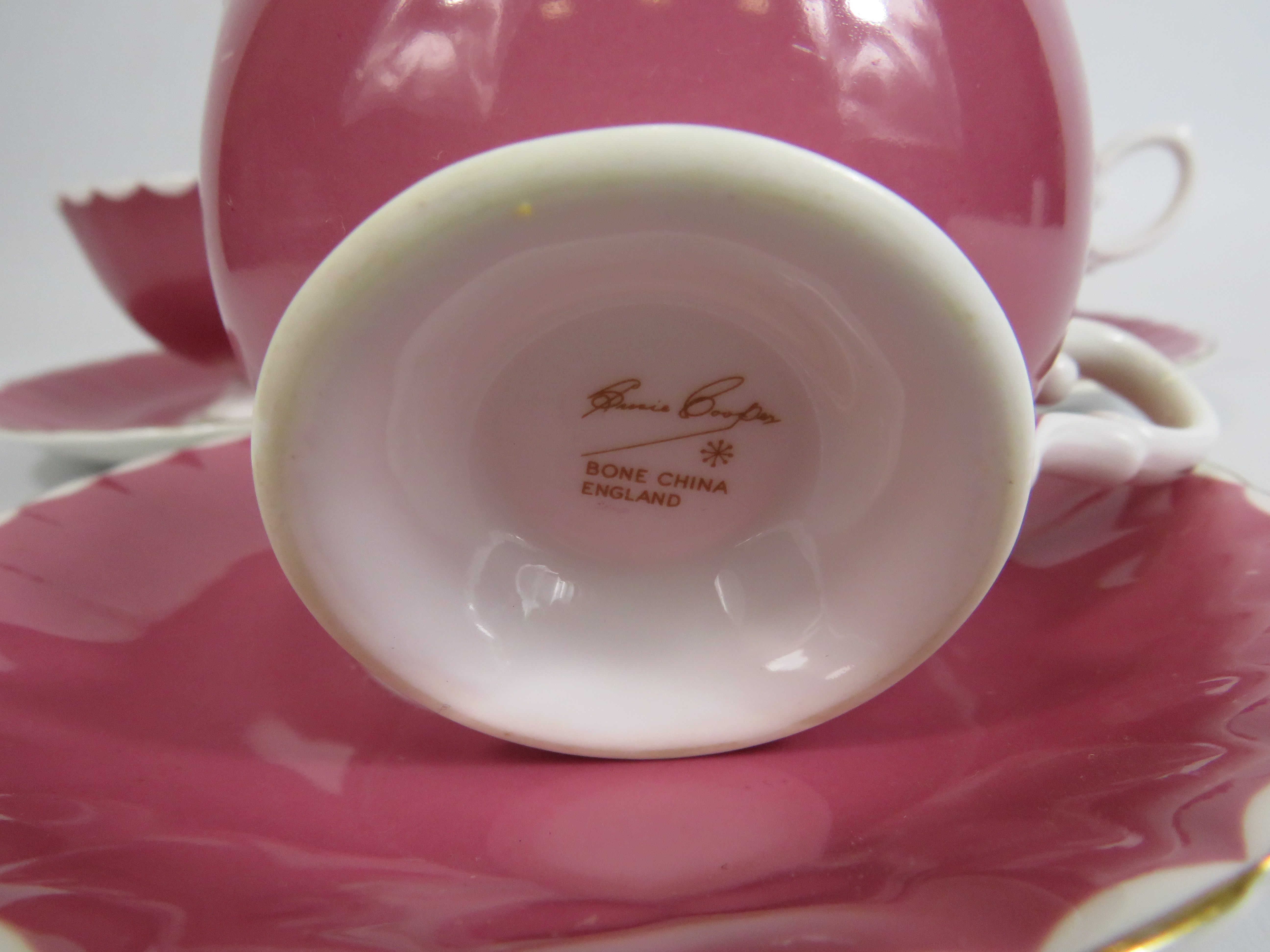 3 Susie Cooper pink cabinet cups and saucers with floral decoration to the bowl. - Image 4 of 4
