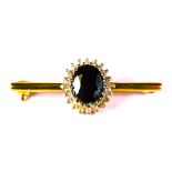 Unusual and high quality 9ct Yellow Gold Sapphire set bar brooch. Central Sapphire with Diamond surr