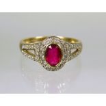 9ct Yellow Gold Ring set with a Central Oval Ruby with Diamonds to Shoulders.  Finger size 'P'    2.