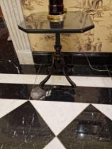 A regency style ebonised side table the canted top mounted on a carved pedestal to bird cage