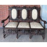 Heavily Carved  settee in late 17th century style. With Cherub Decoration Sofa  The triple-chair