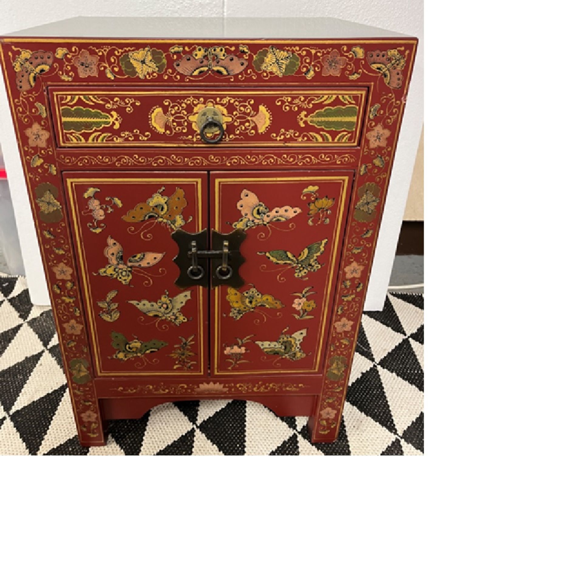 Chinese Lacquered Side Cabinet The cabinet has figurative panels on the front in lacquered gold