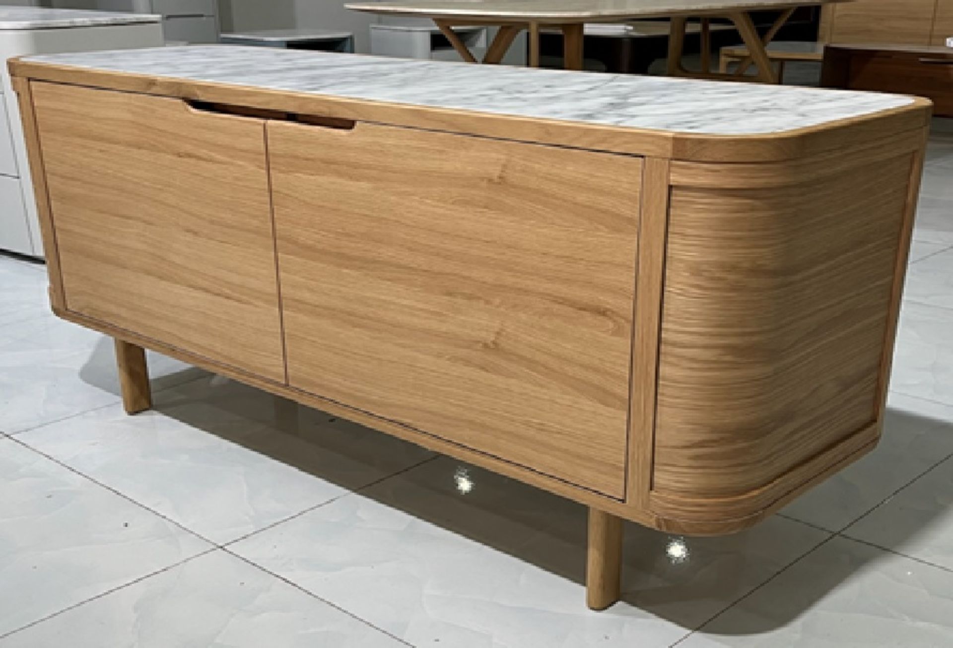 The Asher Sideboard combines a solid walnut frame with Italian Carrara marble to produce a