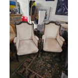 A Pair Of Mid Century French Bergere Chairs Featuring a shaped back topped with a carved cartouche