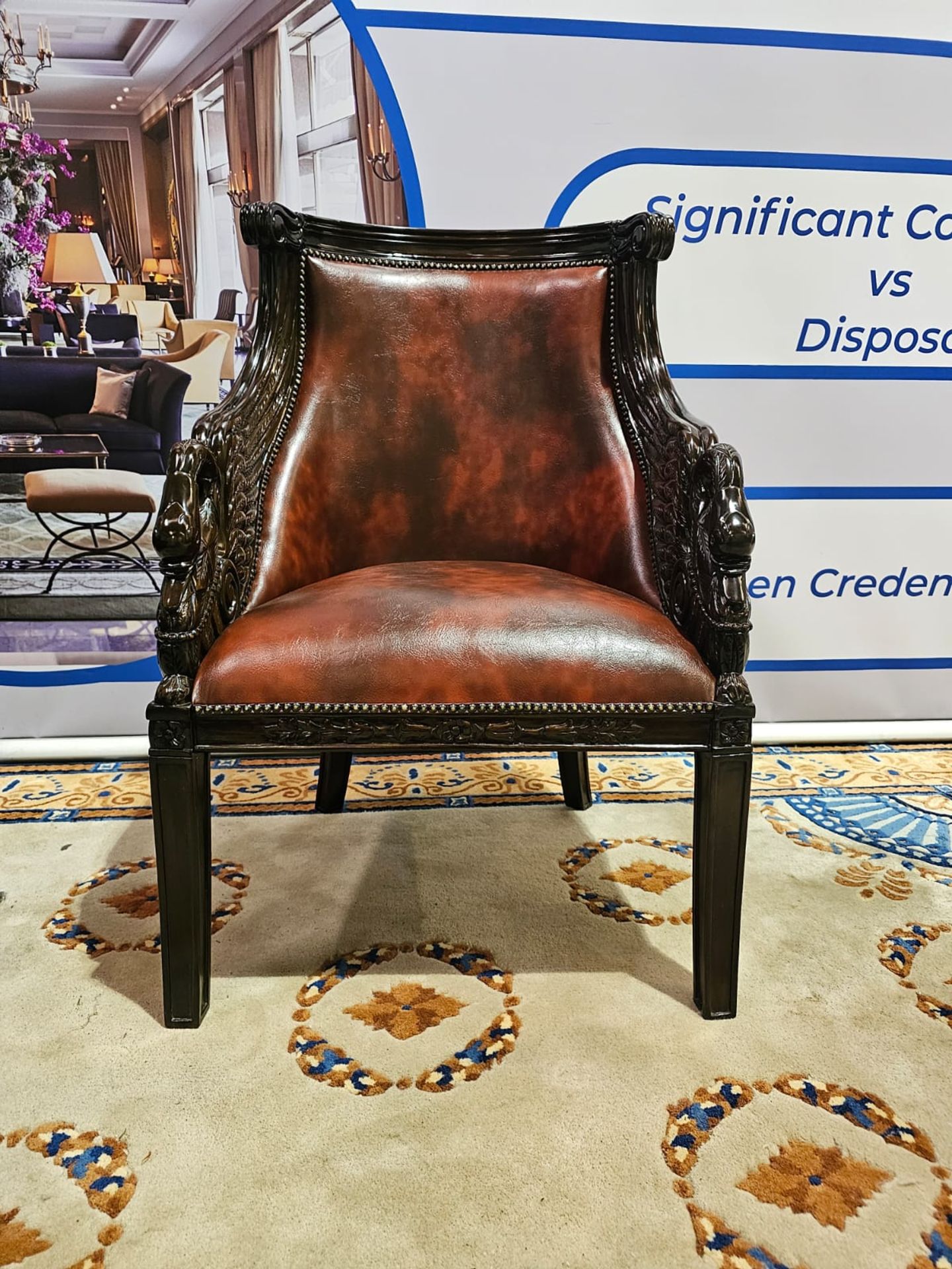 A Ebonised Fauteuil In French Empire Style. The Moulded Curved Toprails Above Padded And Scooped