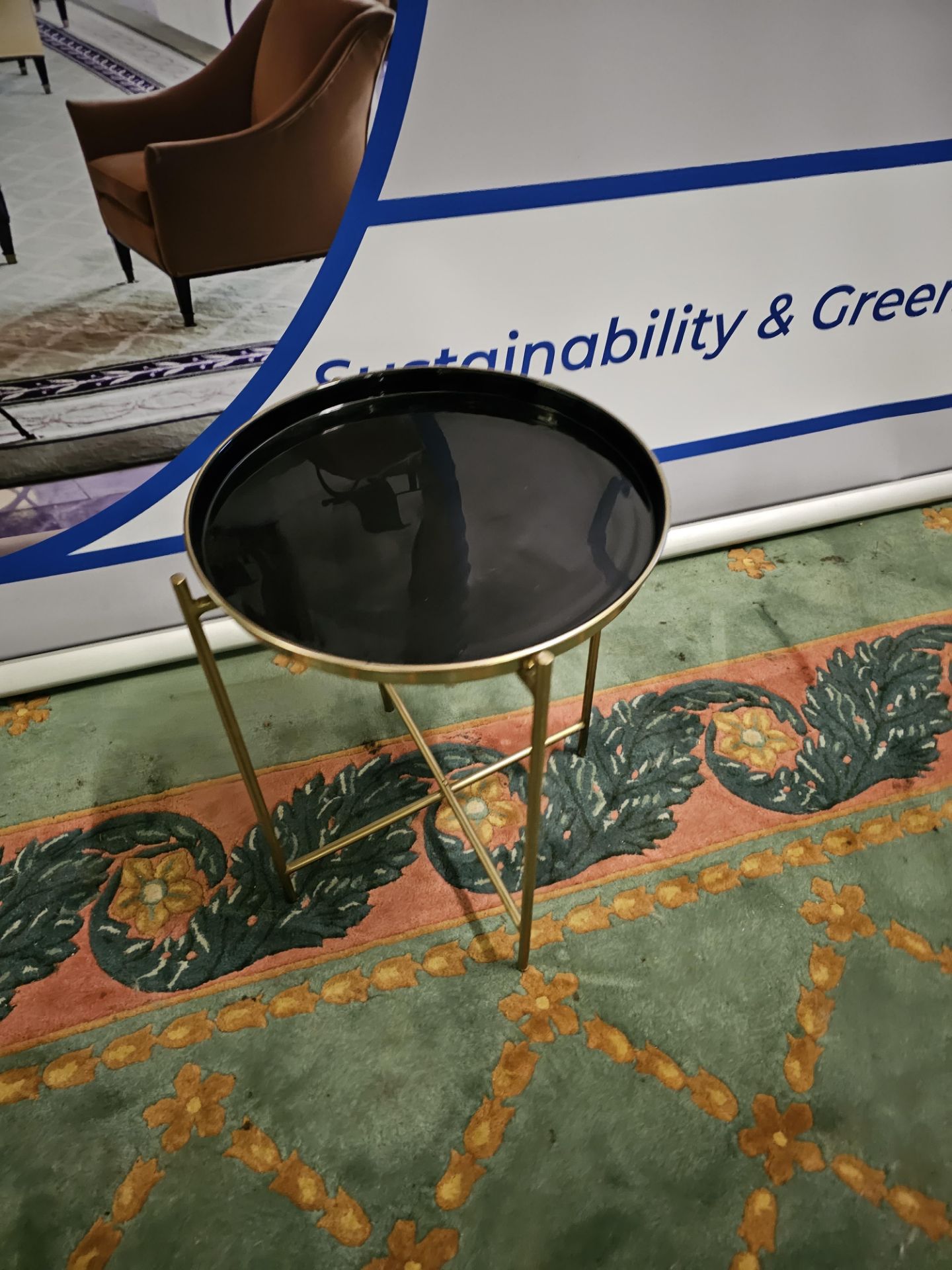 Gallery round metal tray table finished in brass and black Whether you're looking for an accent