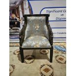 A Ebonised Fauteuil In French Empire Style. The Moulded Curved Toprails Above Padded And Scooped